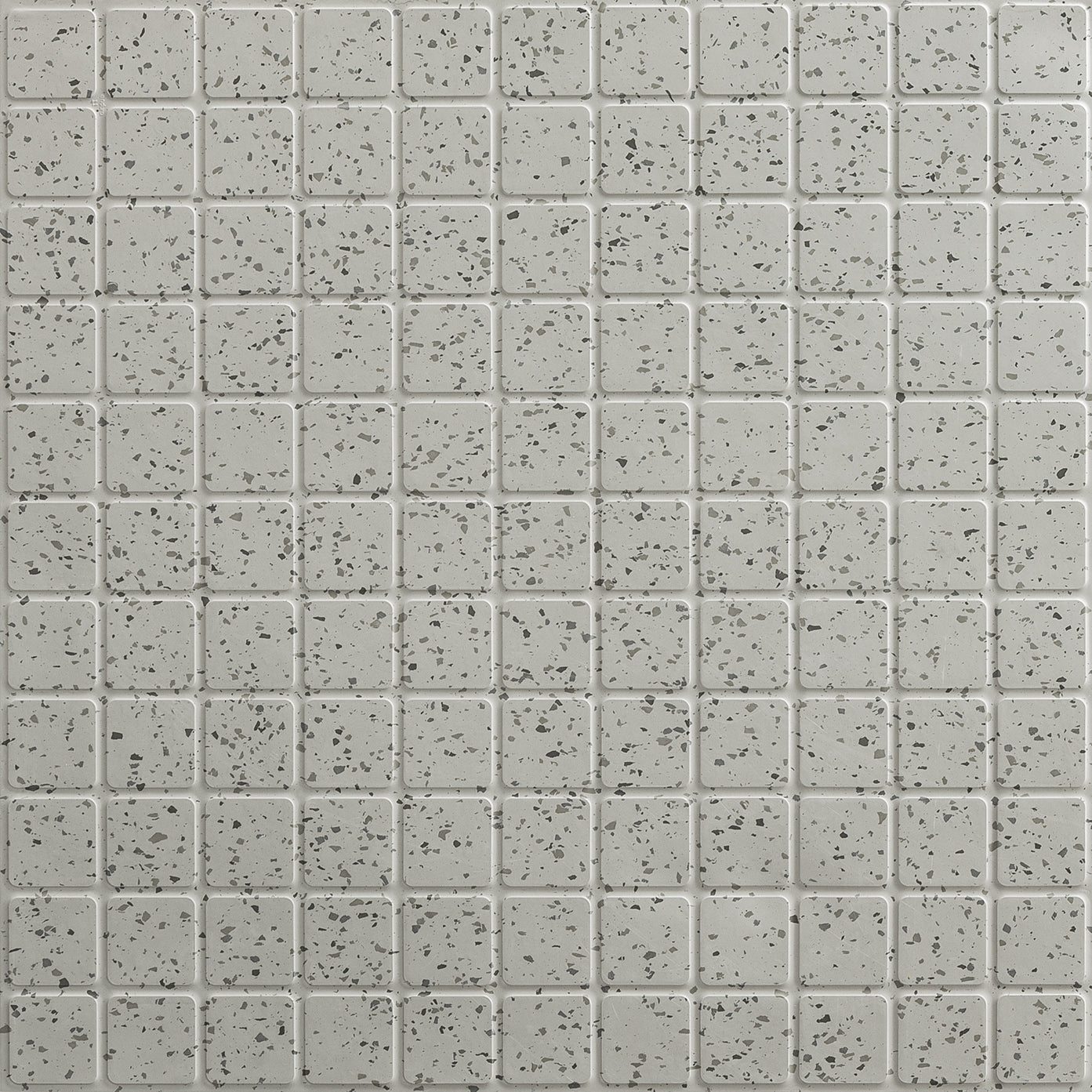Close-up of speckled light gray rubber tile squares with subtle black flecks from the ColorScape collection